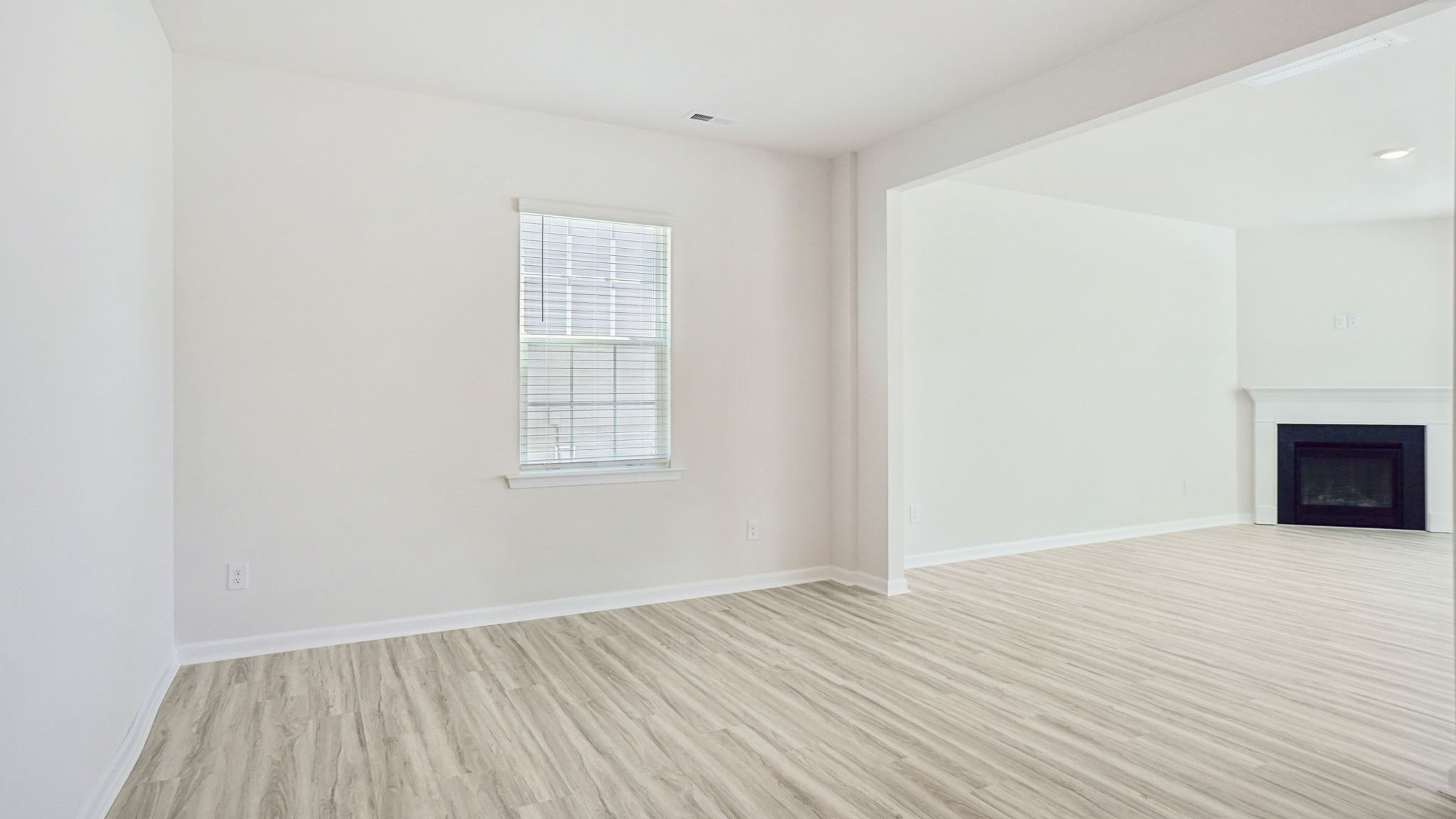 Living room with fireplace and large window
