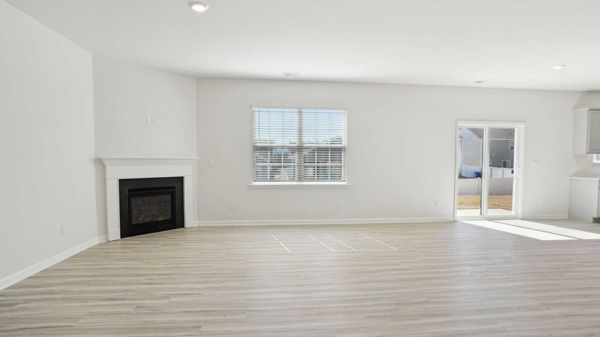 Living room with fireplace and large window