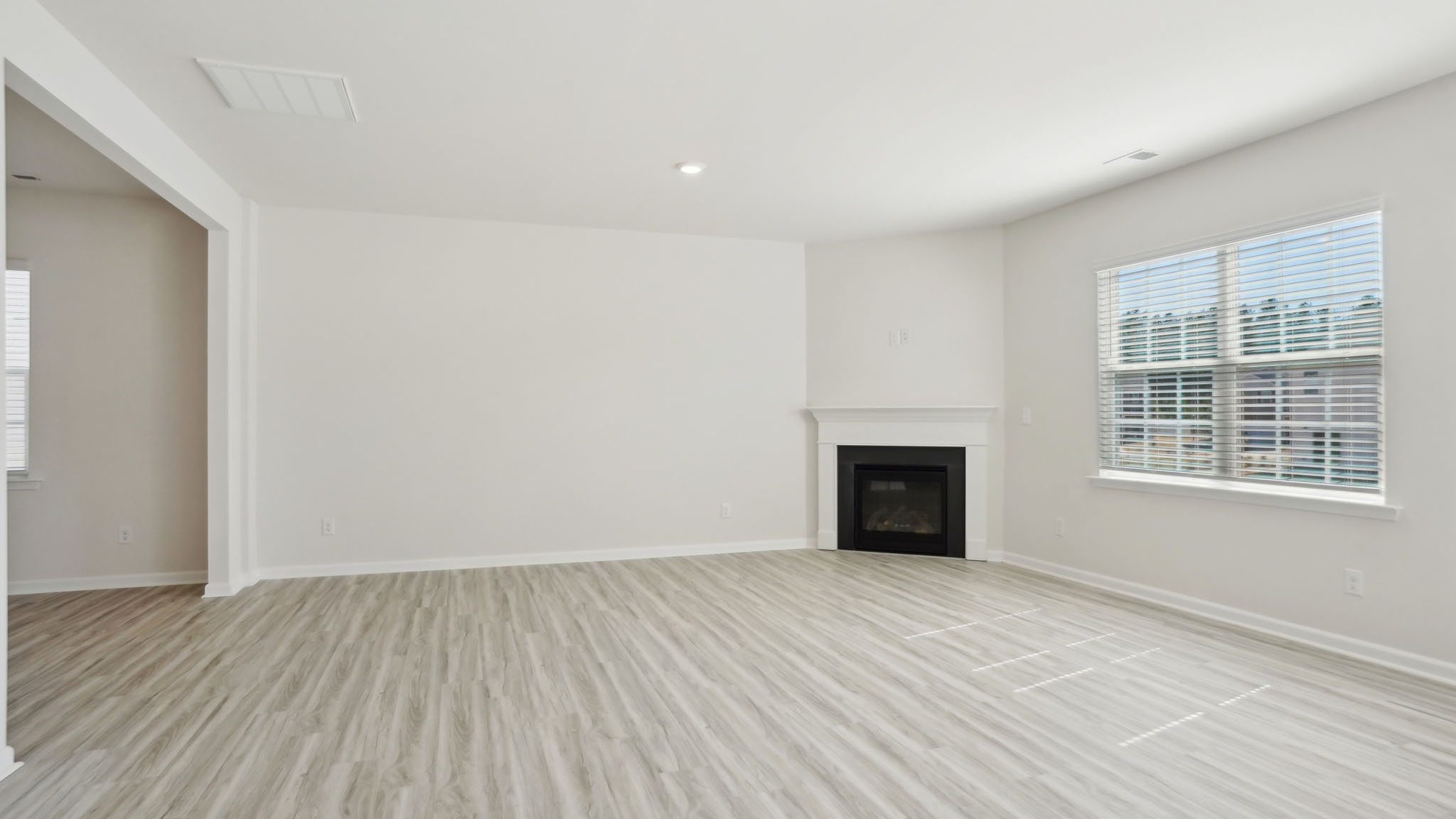Living room with fireplace and large window