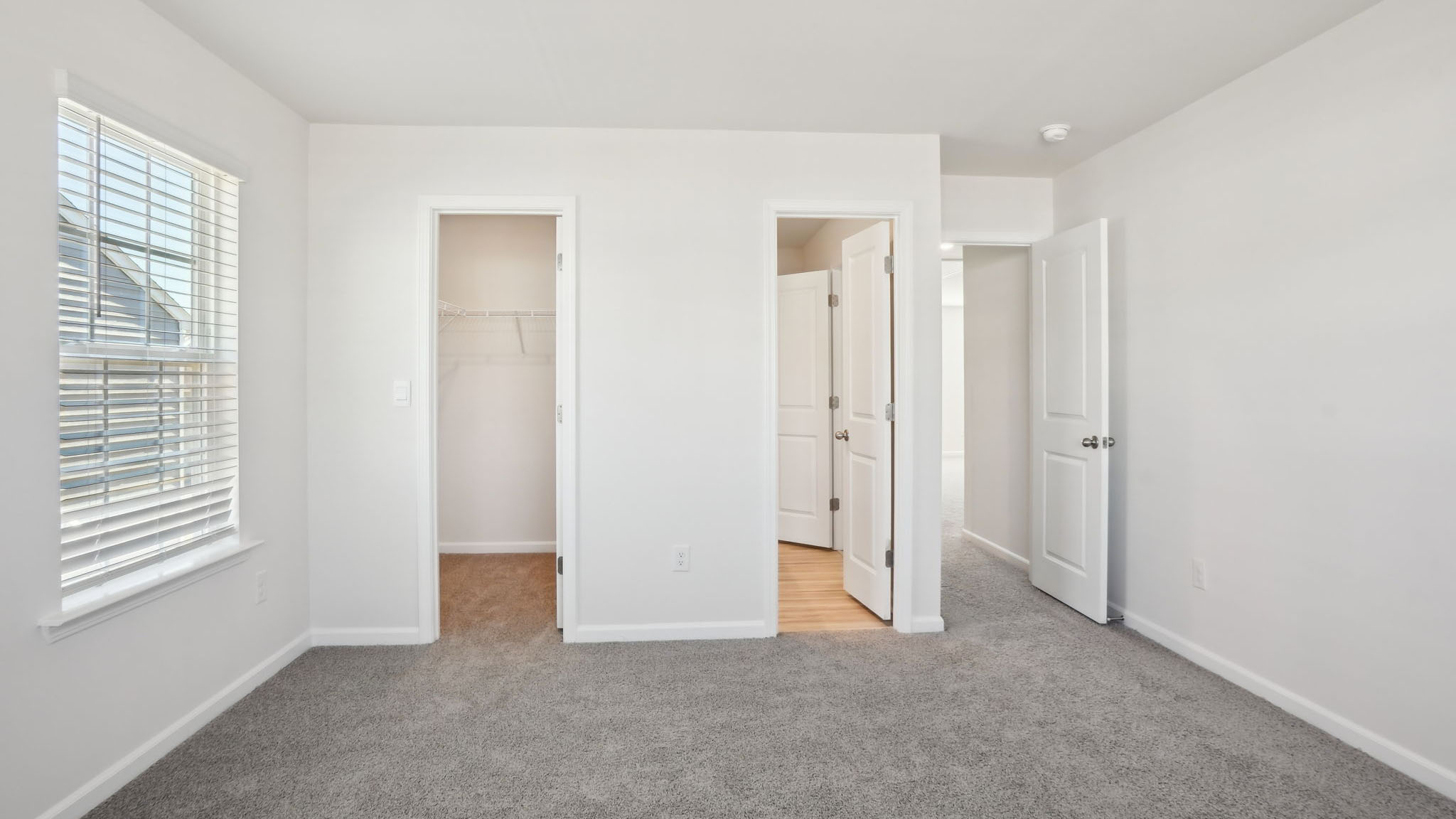 Carpeted bedroom with small windows