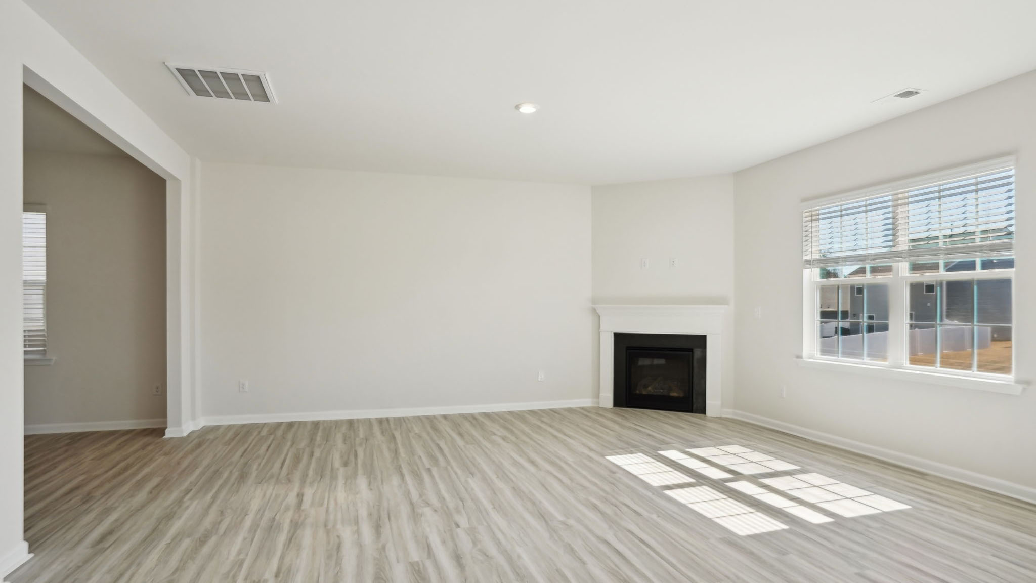Living room with fireplace and large window