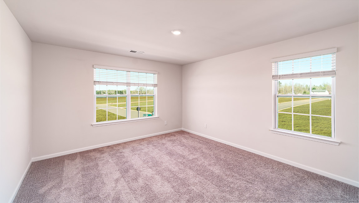 Carpeted bedroom with small windows