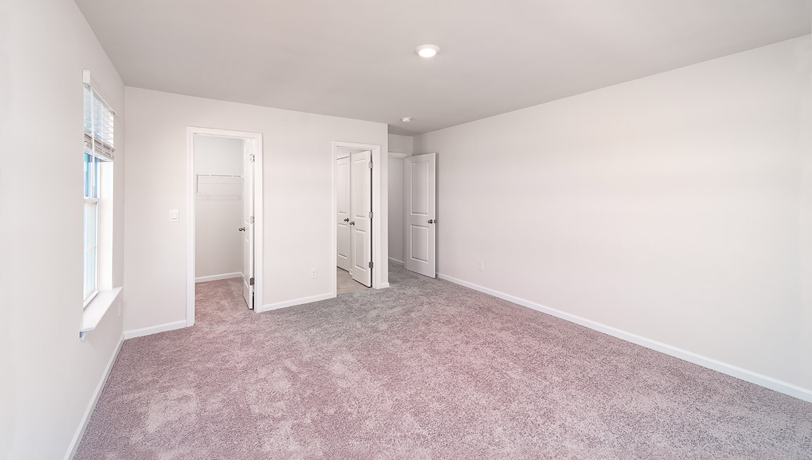 Carpeted bedroom with small windows