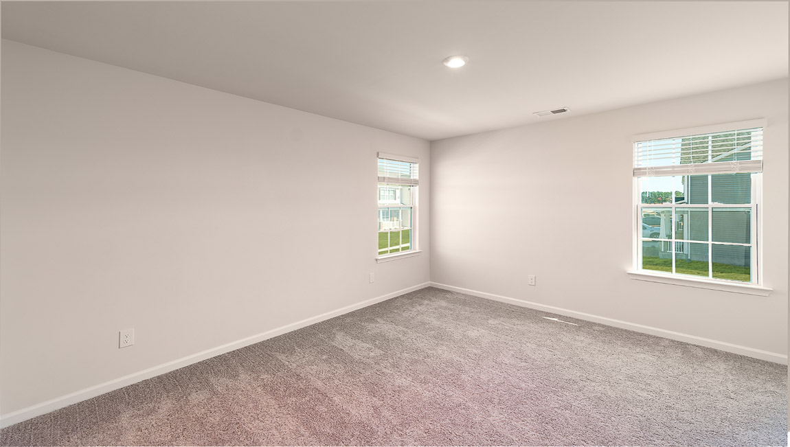 Carpeted bedroom with small windows