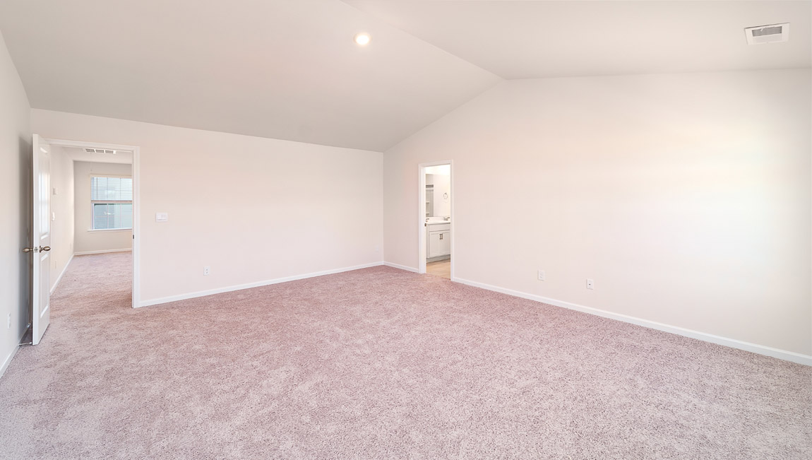 Carpeted bedroom with small windows