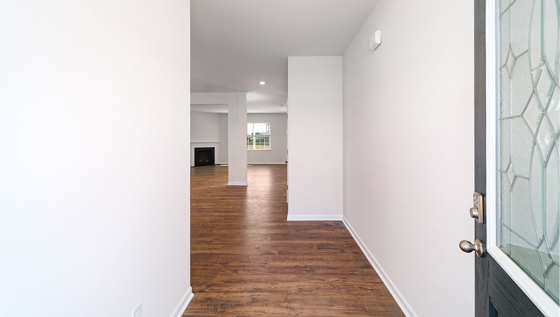 Welcoming foyer with view of flex room, dining and living room