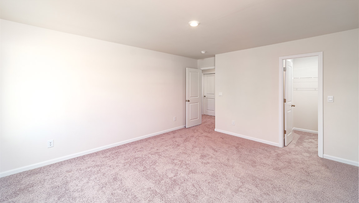 Carpeted bedroom with small windows