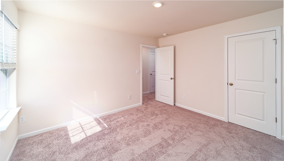 Carpeted bedroom with small windows