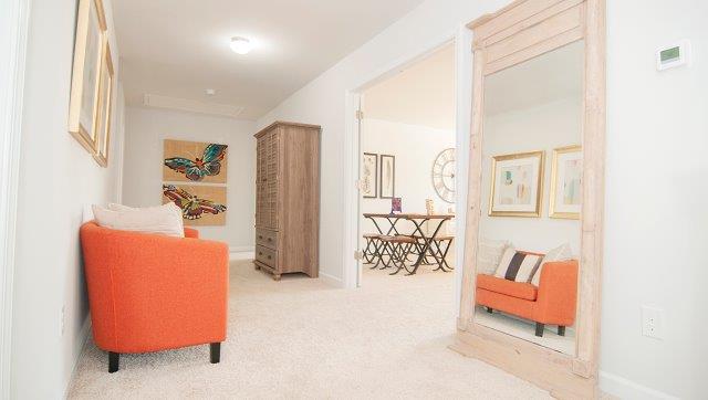 Carpeted bonus room with large windowCarpeted bonus room with large window