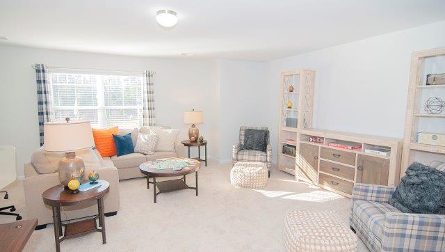 Carpeted bonus room with large windowCarpeted bonus room with large window