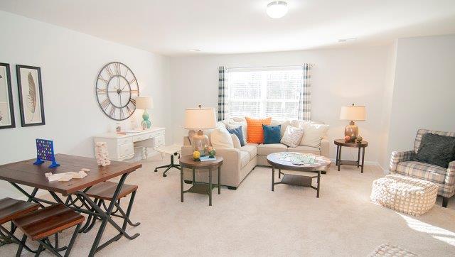 Carpeted bonus room with large windowCarpeted bonus room with large window