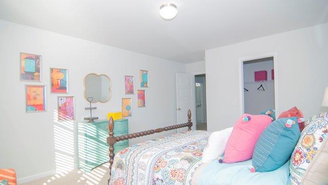 Carpeted bedroom with large window