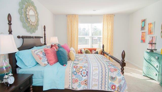 Carpeted bedroom with large window
