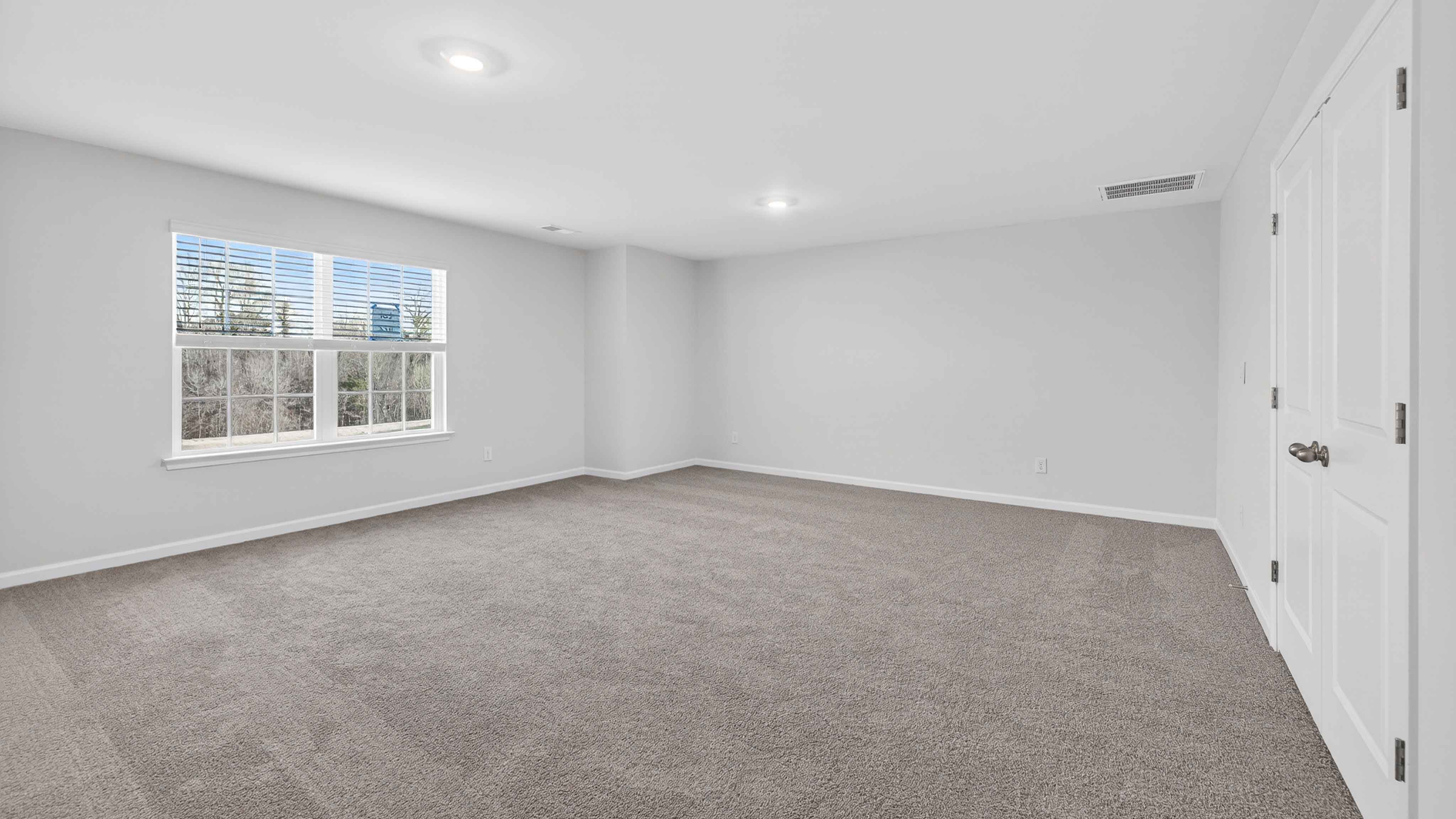 Carpeted bedroom with large window