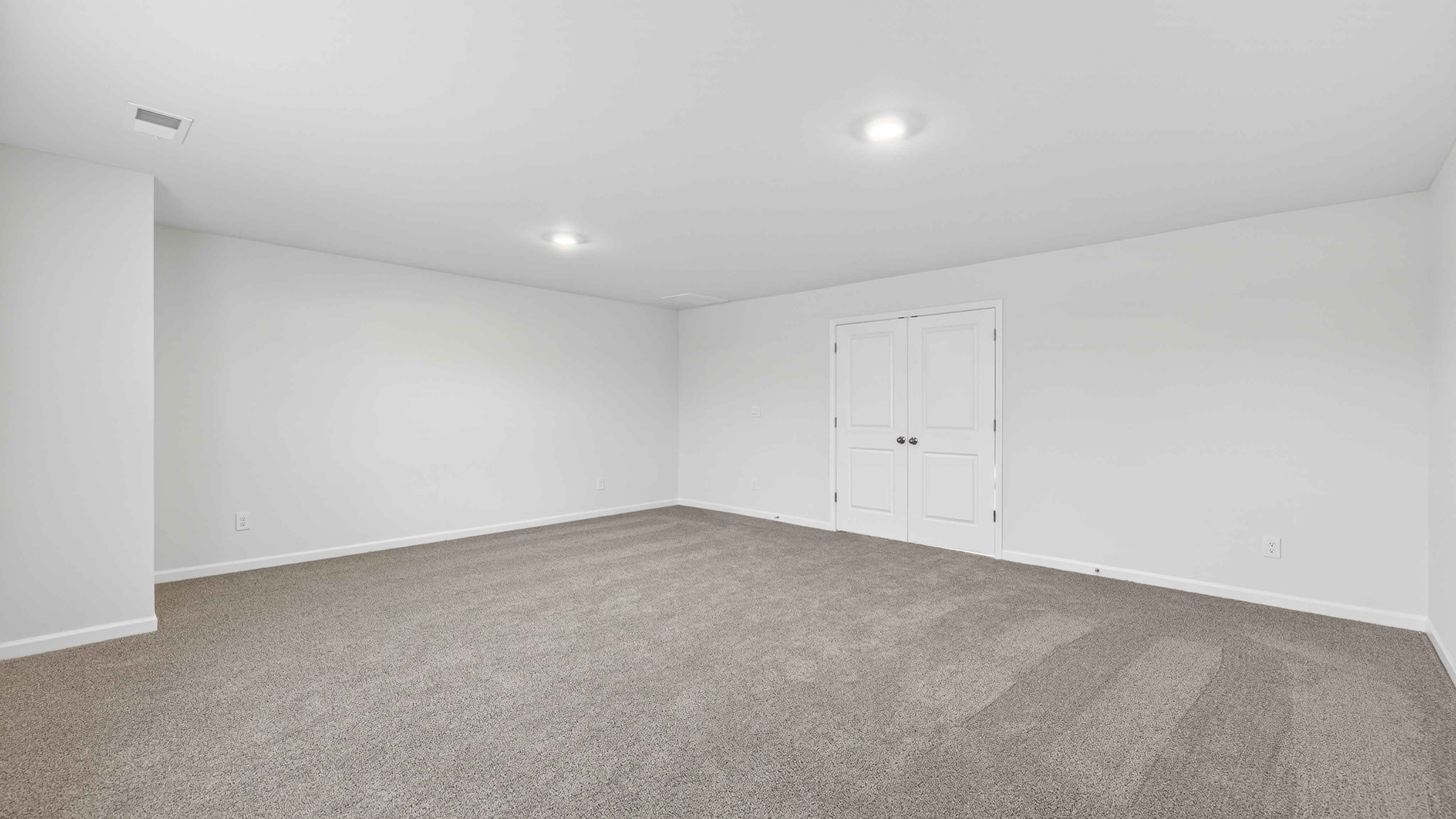 Open carpeted flex area with windows