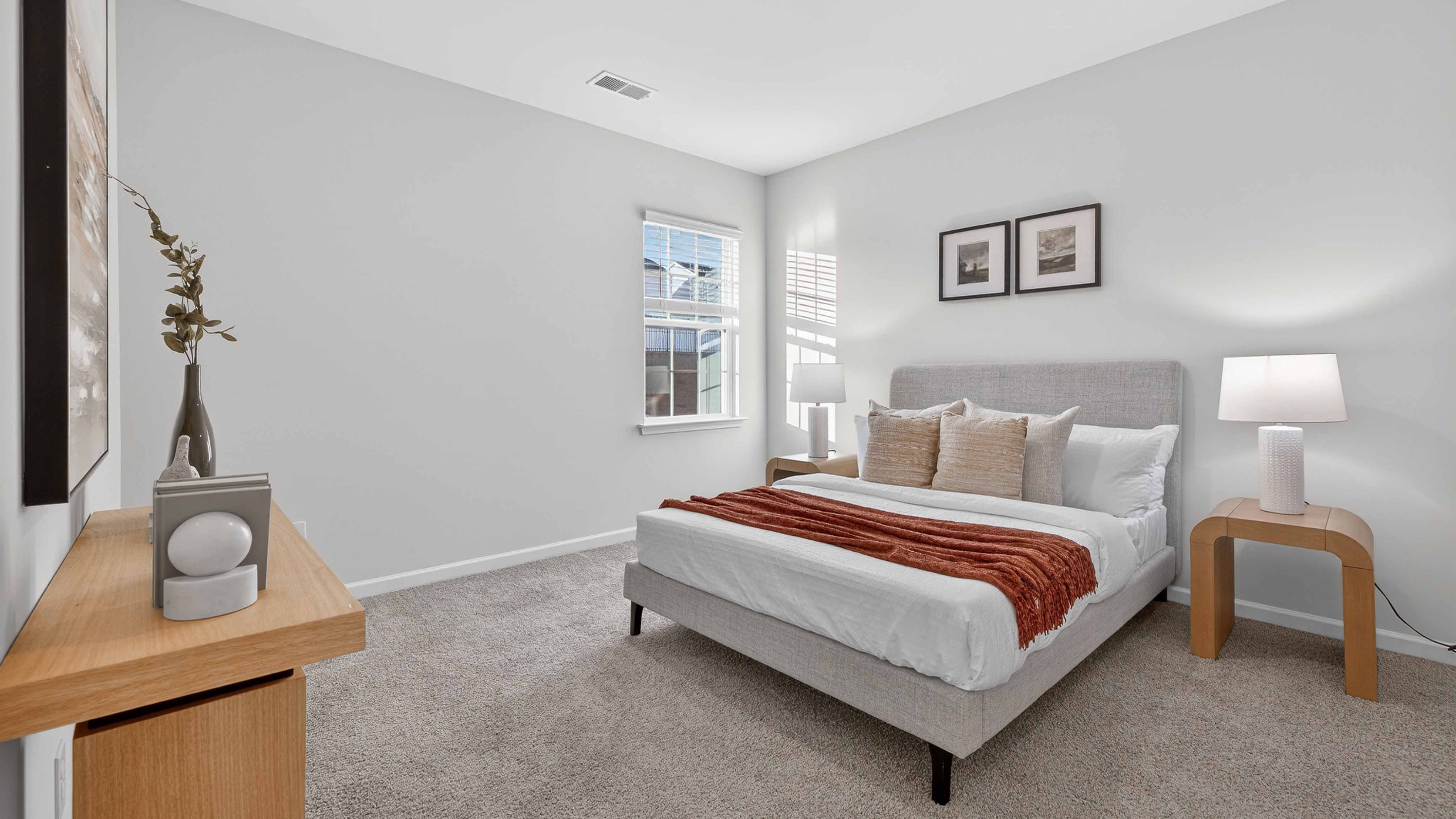 Carpeted bedroom with large window
