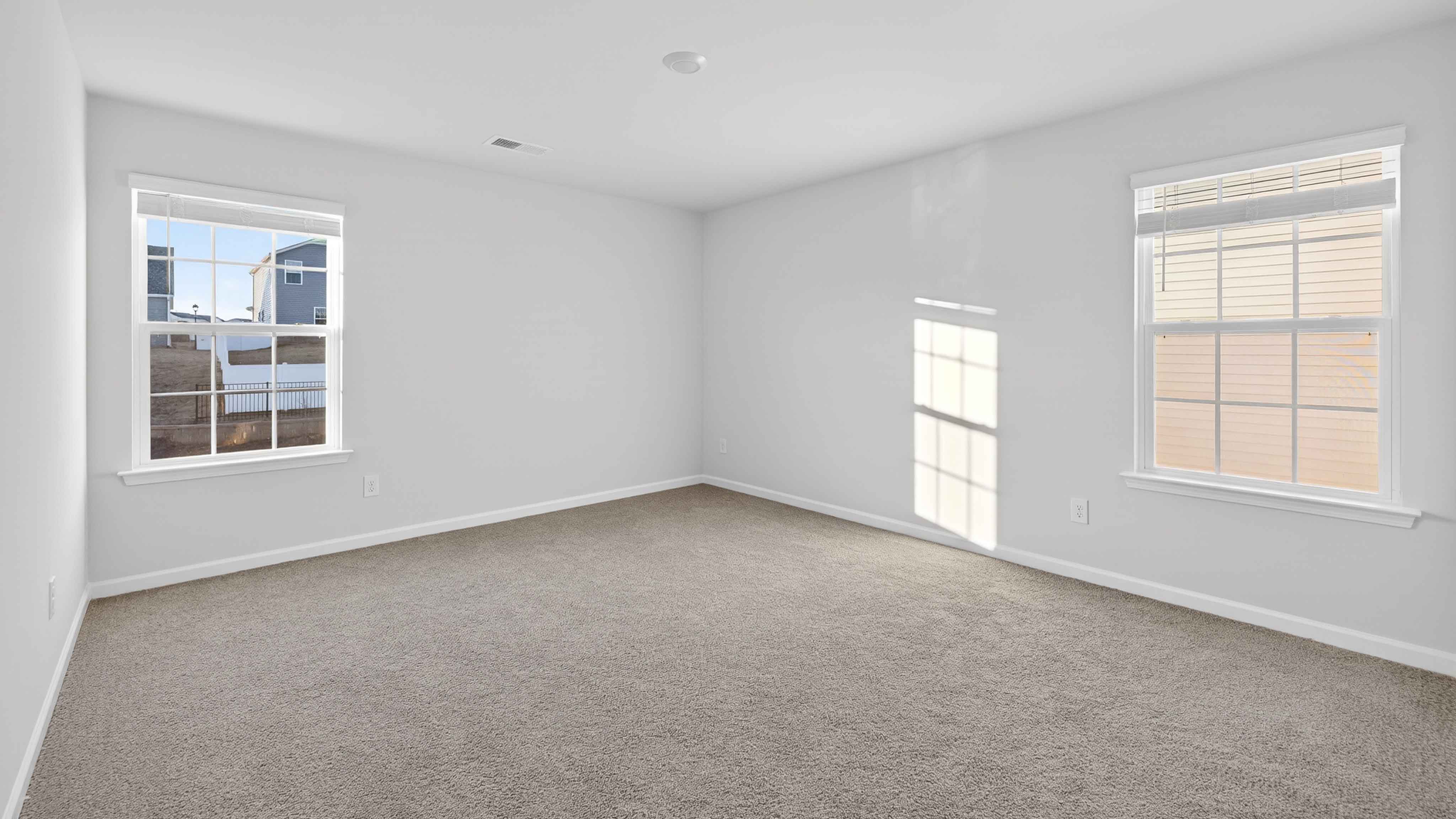 Carpeted bedroom with large window