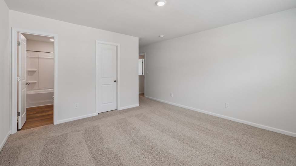 Carpeted bedroom with large window