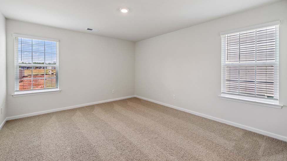 Carpeted bedroom with large window