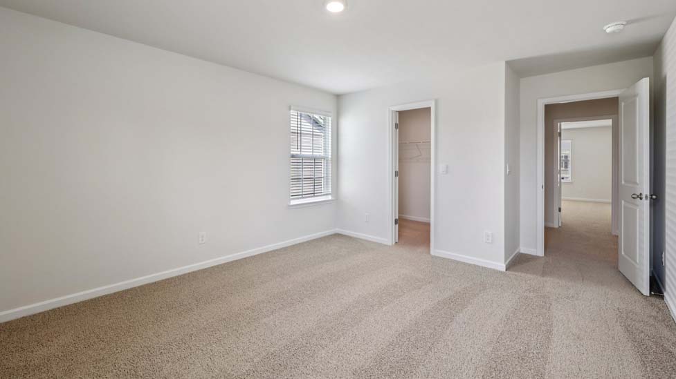 Carpeted bedroom with large window