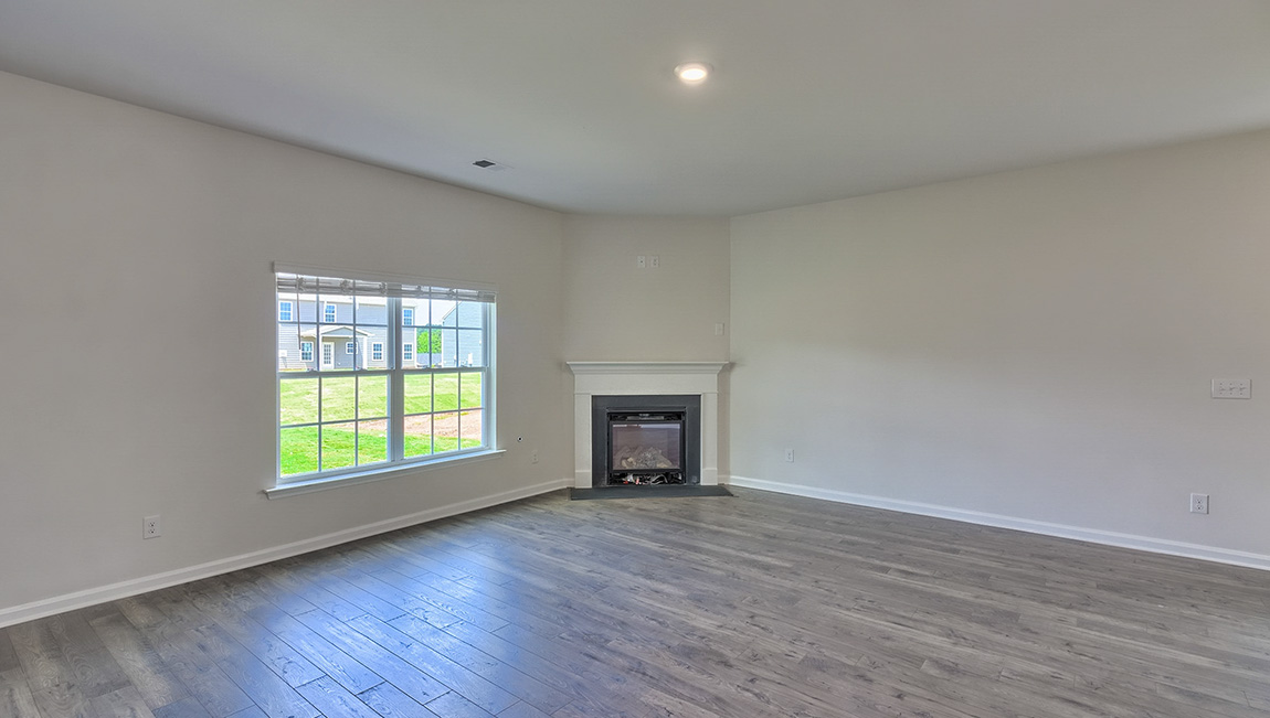Spacious family room with large window and fireplace
