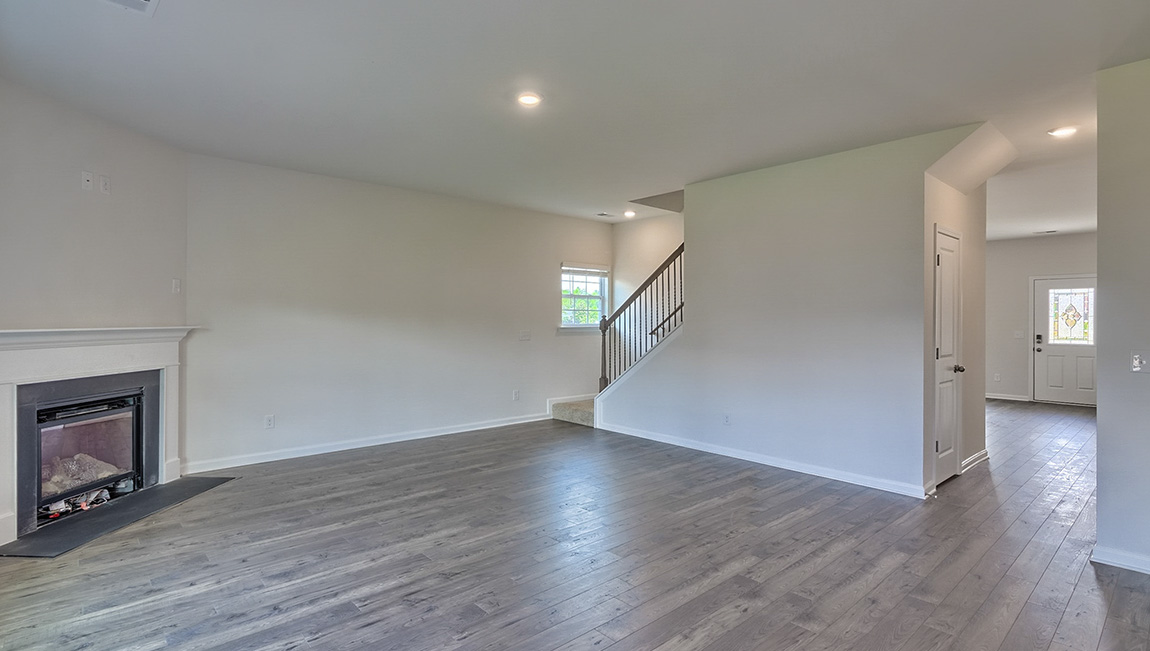Spacious family room with large window and fireplace