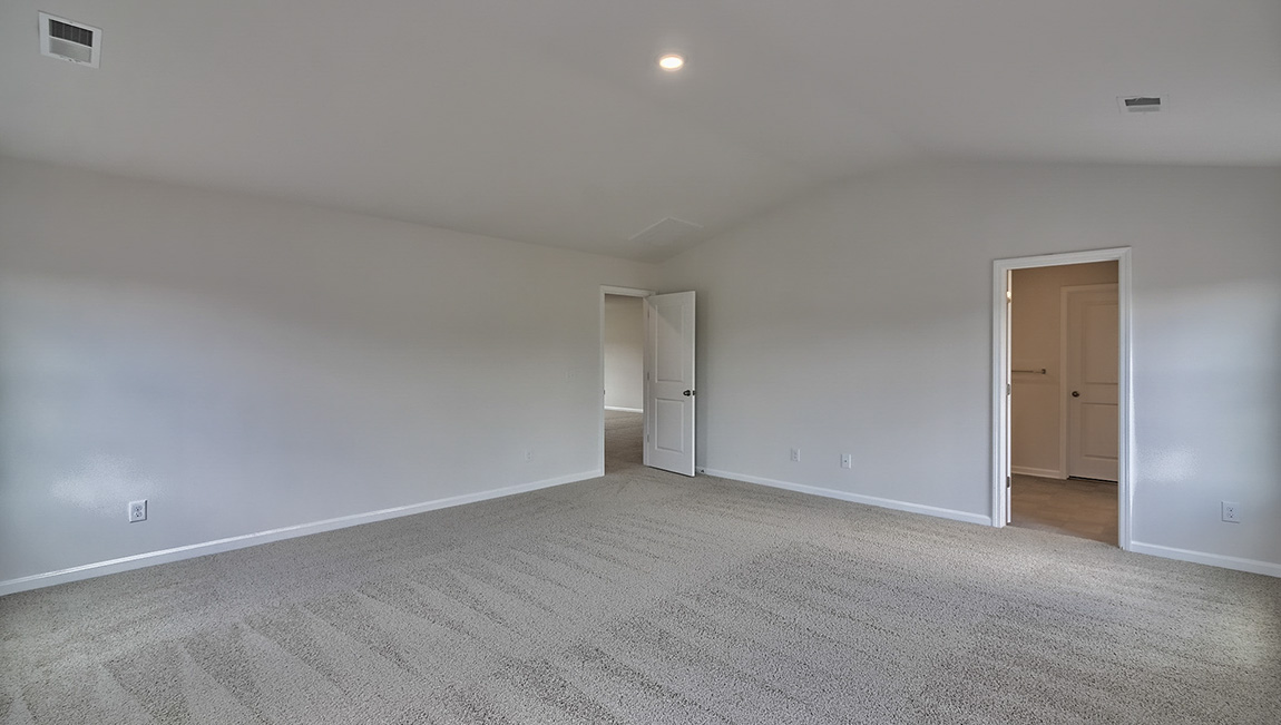Primary carpeted bedroom  with 4 windows