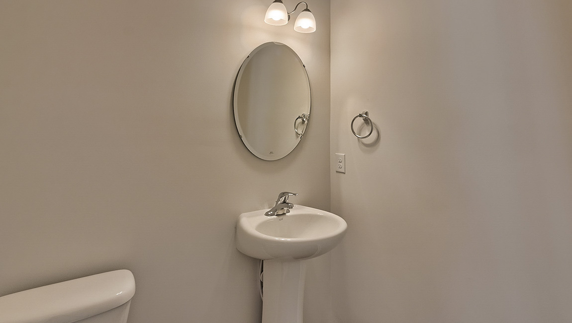 Powder bathroom with small sink and mirror