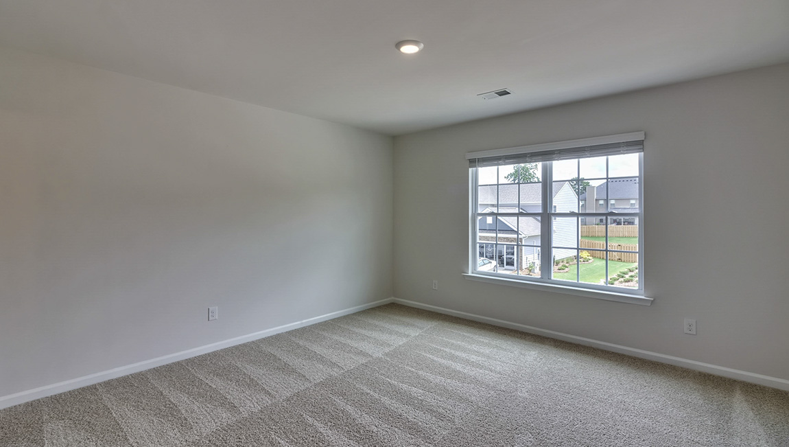 carpeted bedroom with large window
