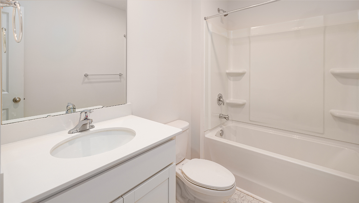 Bathroom with bathtub, white counters and cabinets