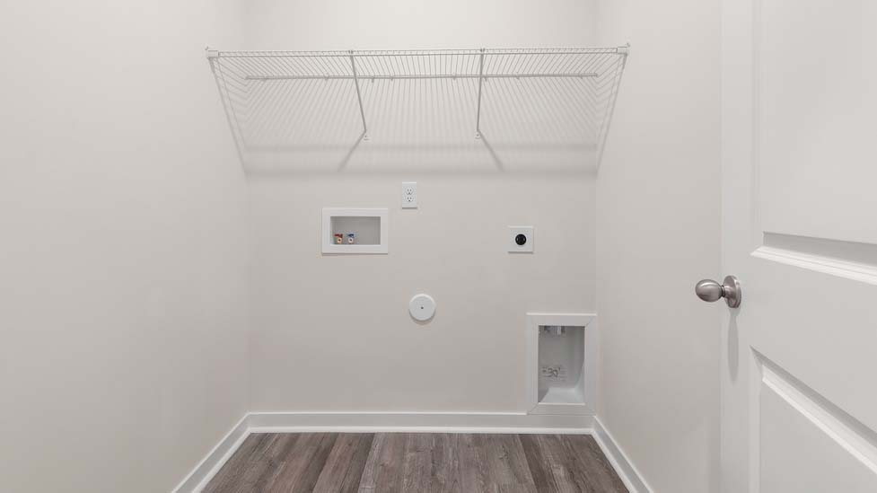 Laundry room with storage and hanging racks above machines