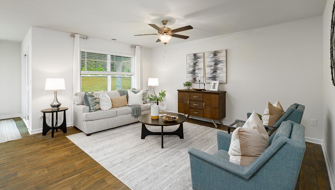Open living room with ceiling fan and large window