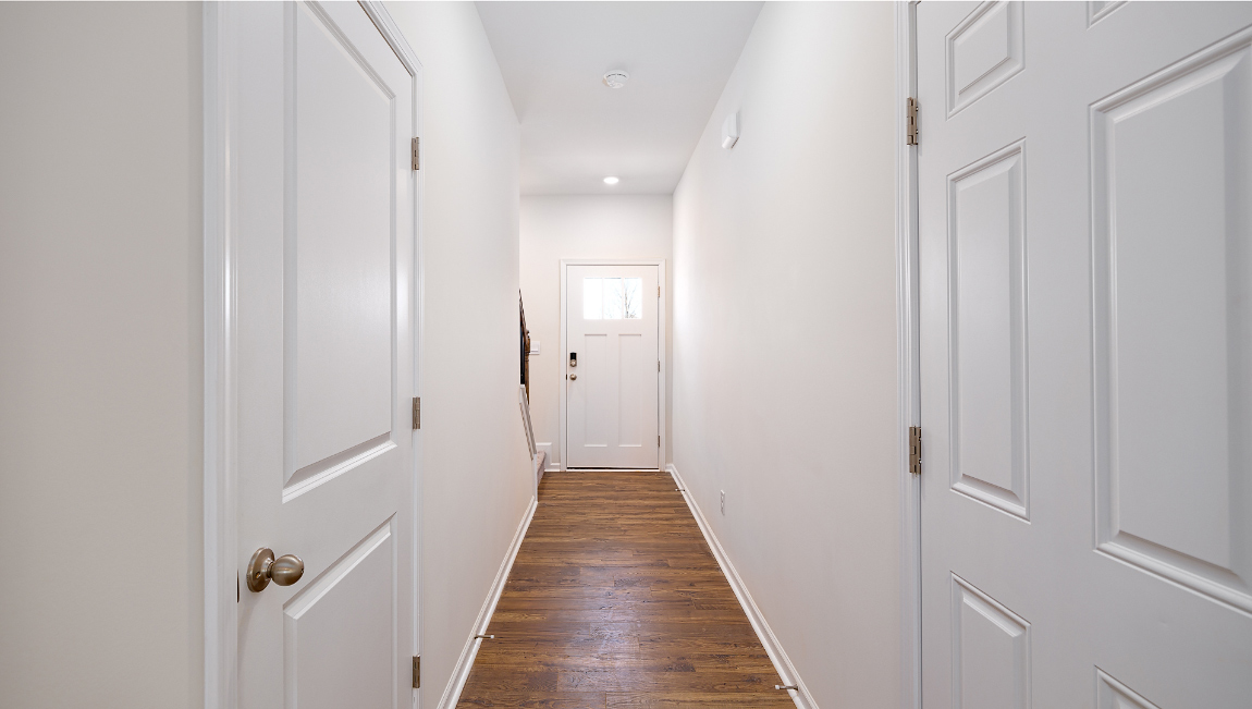 Welcoming foyer with wood floors, view of front door