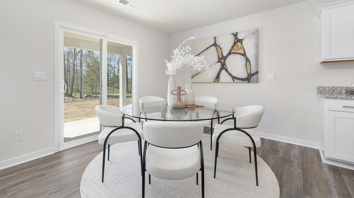 Dining area with wood floors and sliding glass back door