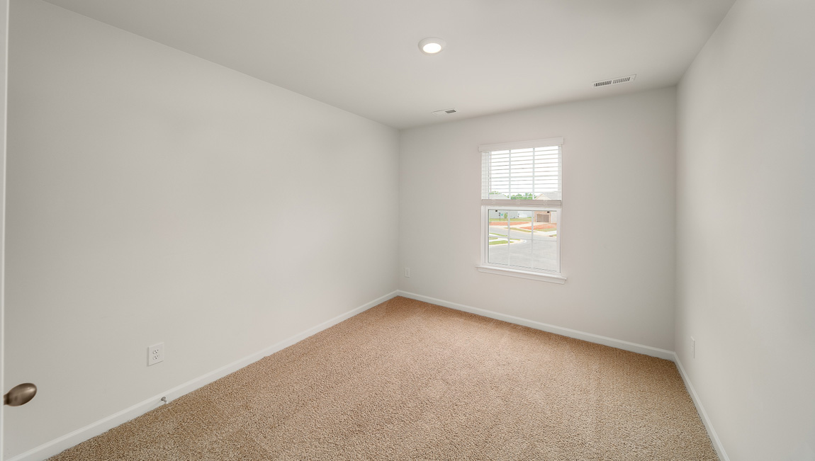 Carpeted bedroom with window