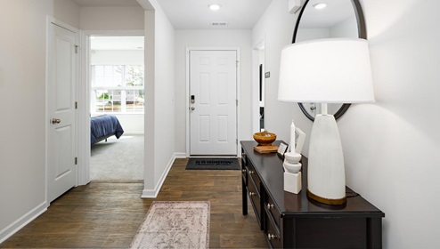 Welcoming foyer with vinyl flooring, view of front door. New Home in Charlotte, North Carolina