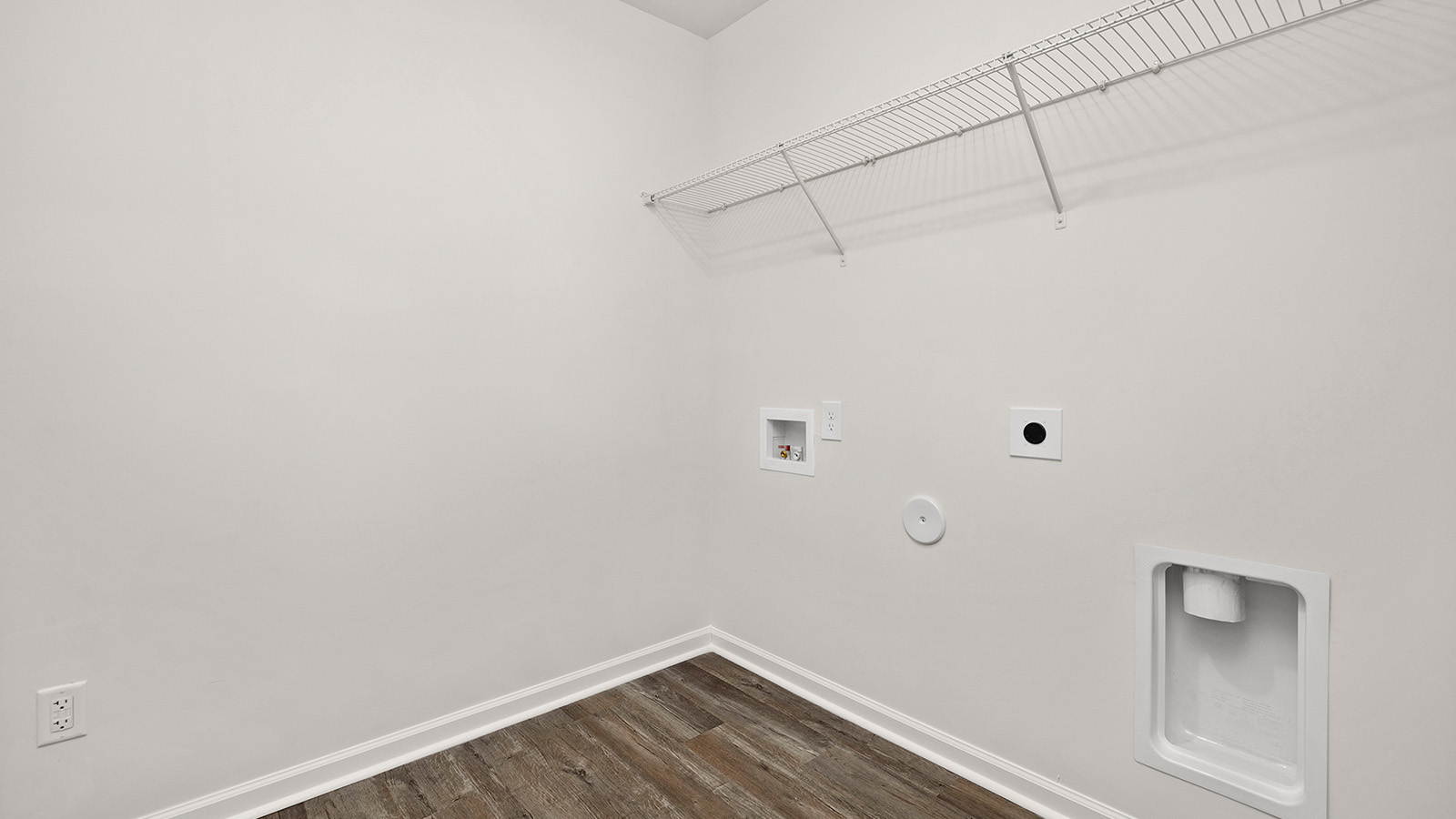 Laundry room with storage hanging racks above machines