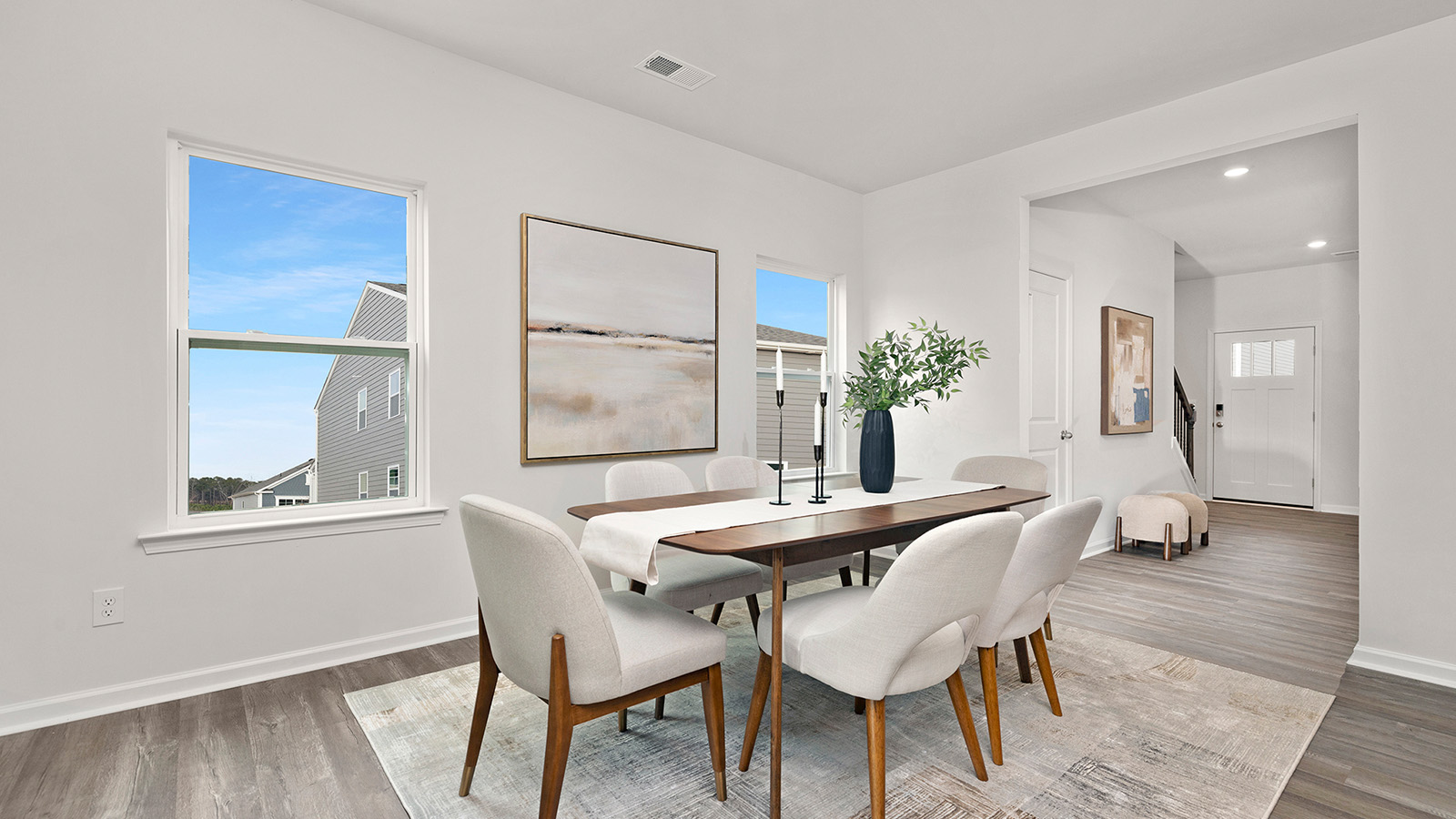 Dining Room in view of family room, wood floors, two windows alongside