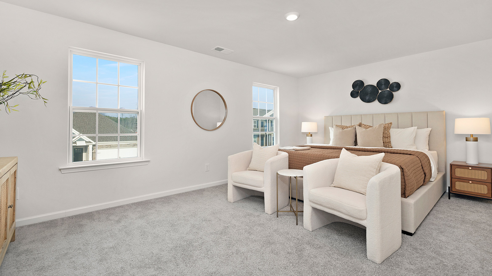 Primary bedroom, carpeted with two large windows