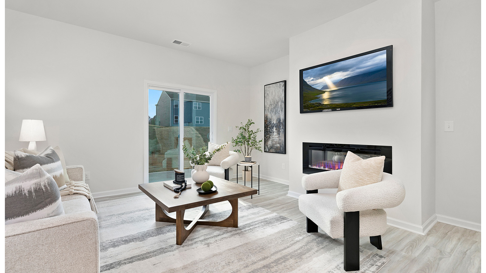 Open living room beside kitchen and dining with electric fireplace and large window