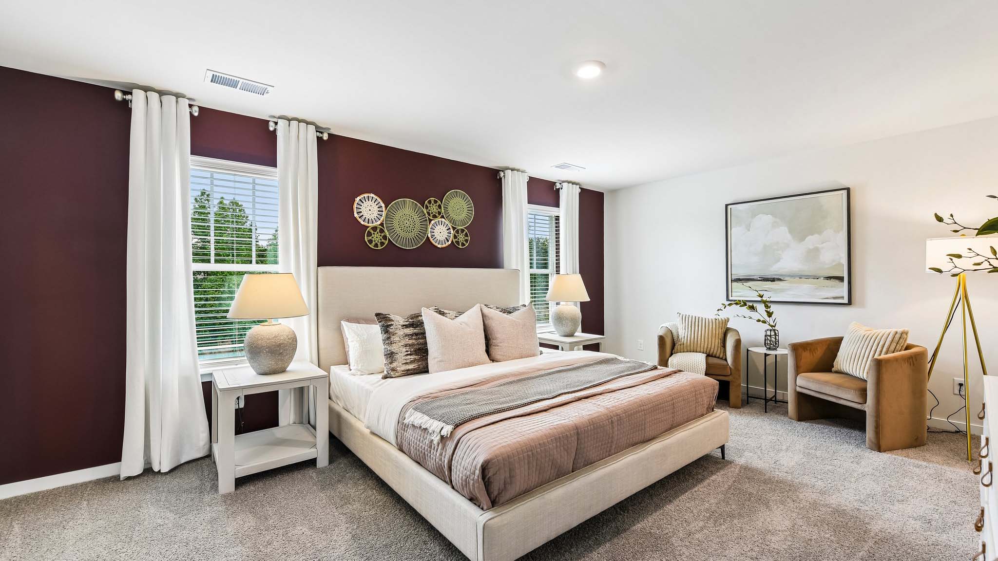 Primary carpeted bedroom with windows