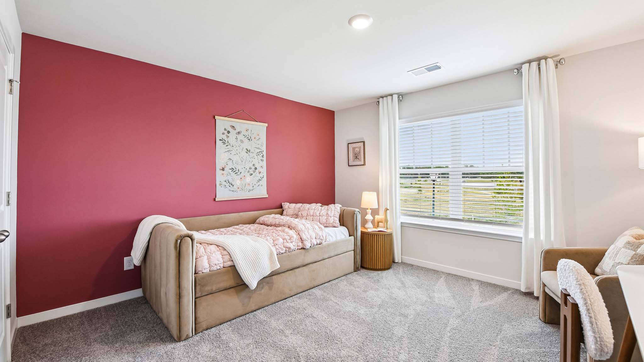 Carpeted bedroom with windows