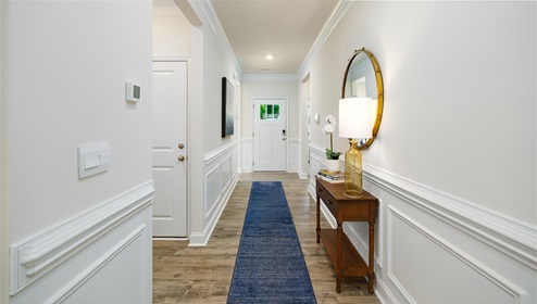 Welcoming foyer, view of front door, with wood floors