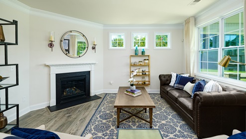 Living room space with large window and fireplace