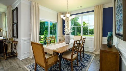 Dining area with 2 large windows and wood floors