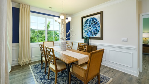 Dining area with 2 large windows and wood floors
