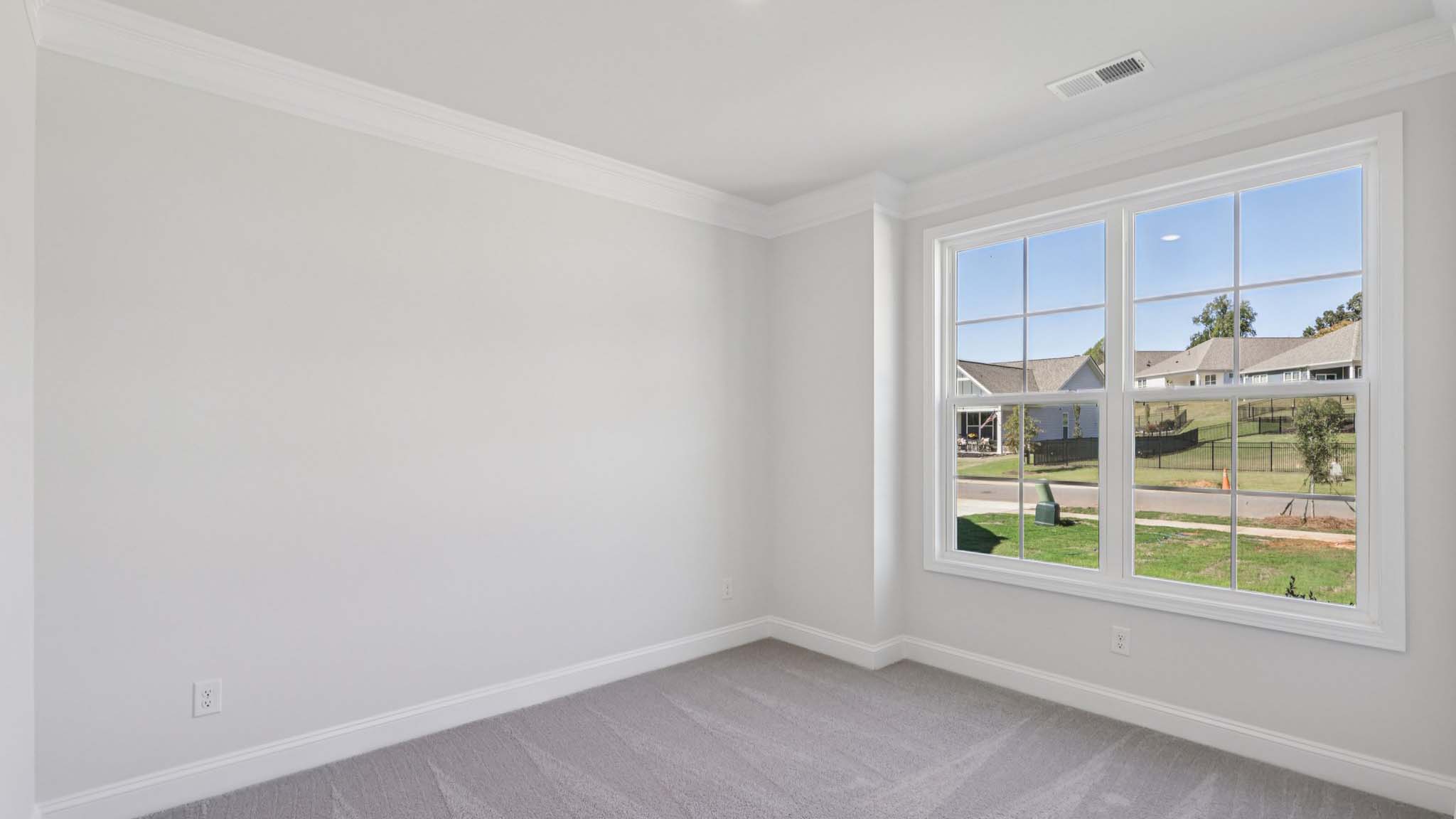 Carpeted bedroom with large window