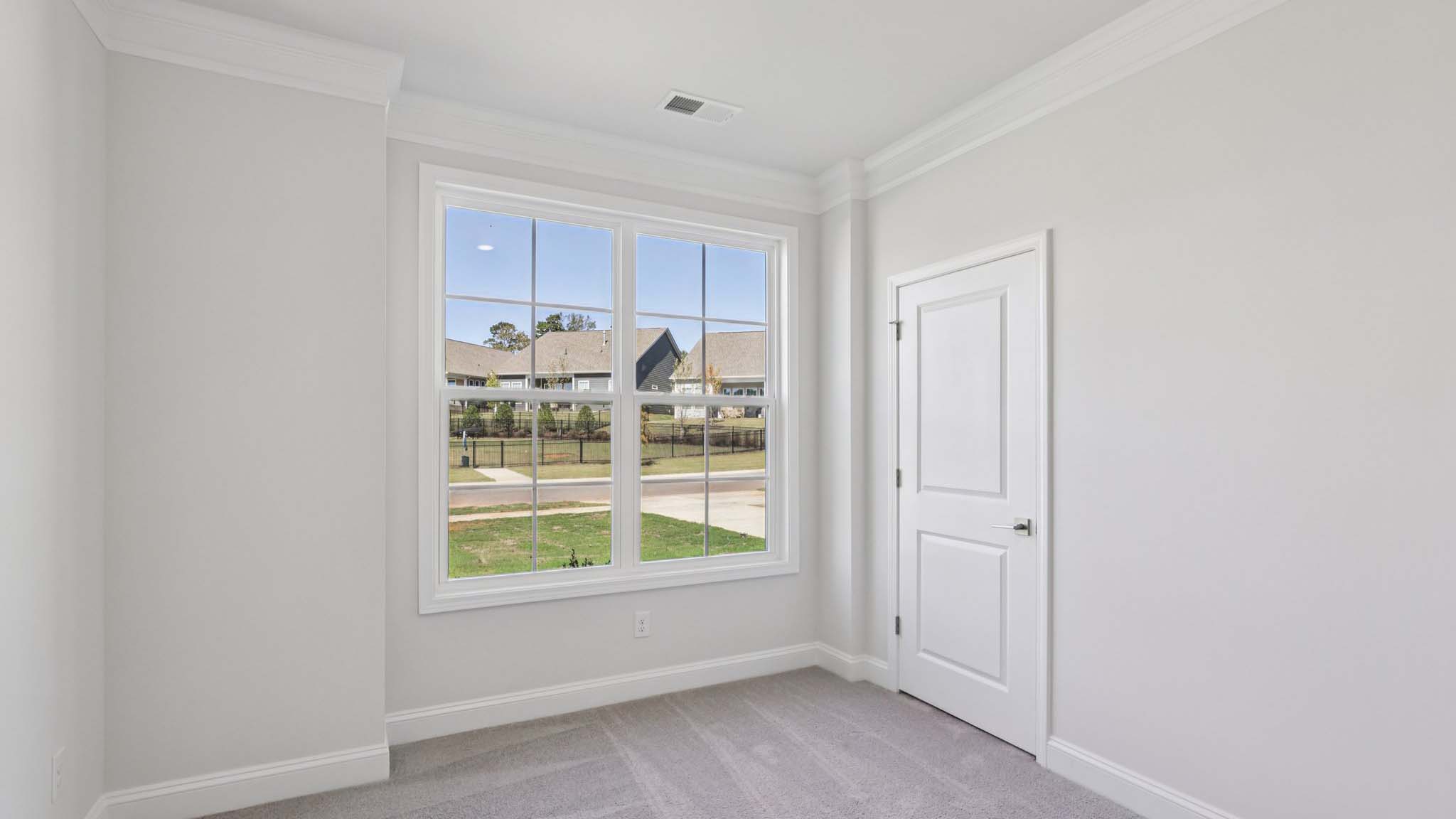 Carpeted bedroom with large window