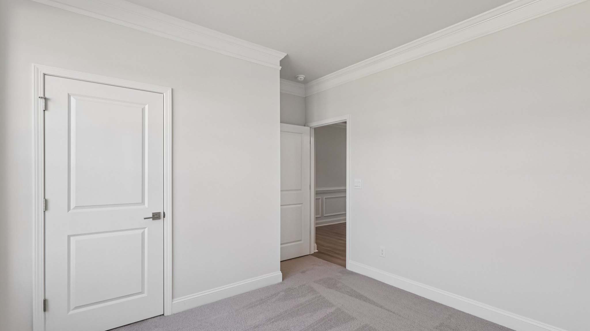 Carpeted bedroom with large window
