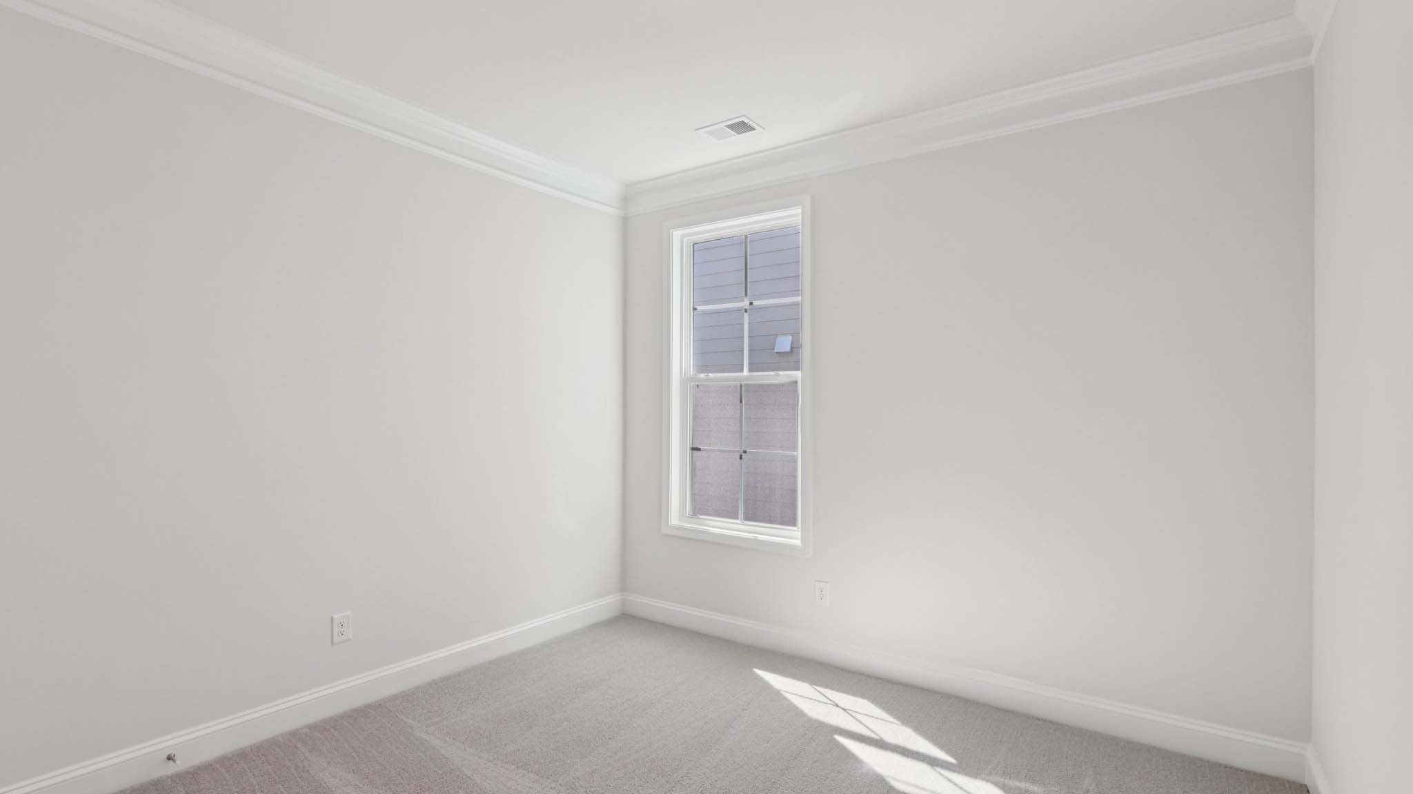 Carpeted bedroom with large window